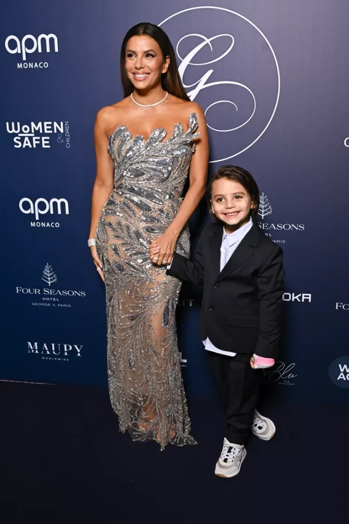 Eva Longoria Sparkly Sheer Dress Smiling Holding Hand of Son Santiago at Global Gift Gala October 5, 2024
