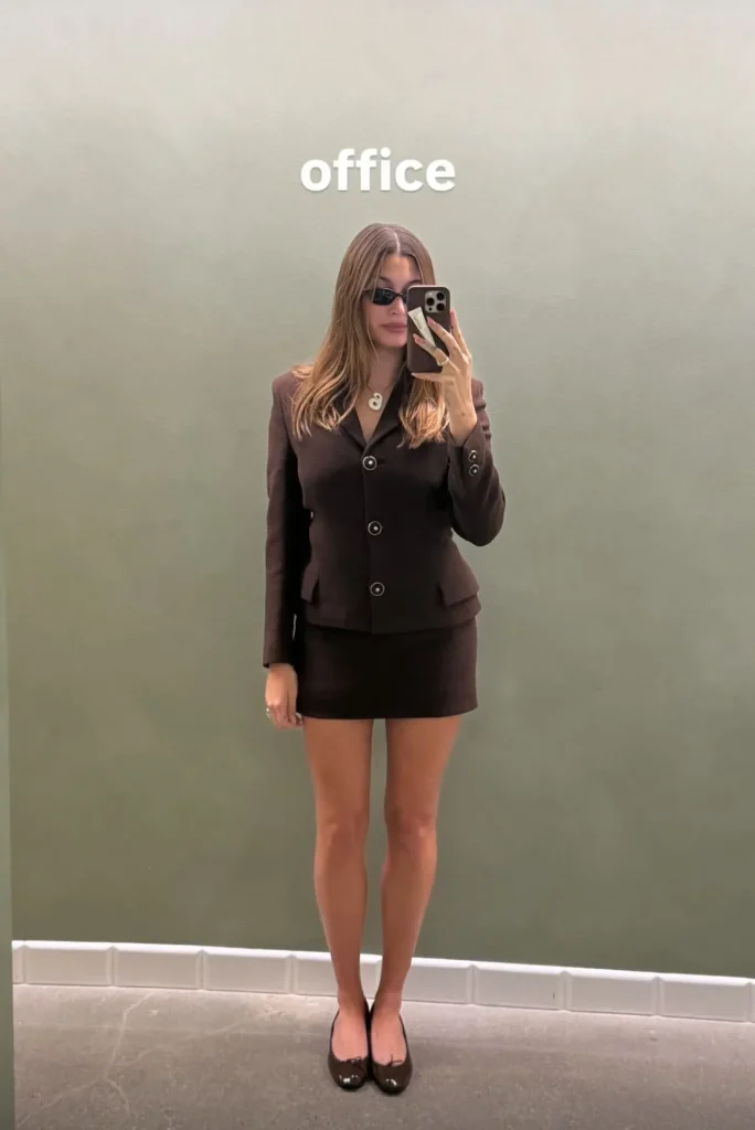 Image may contain Hailey Baldwin Clothing Skirt Formal Wear Suit Blouse Blazer Coat Jacket Adult and Person
Hailey Bieber opted for a vintage Versace skirt suit from the ’90s for her return to the office