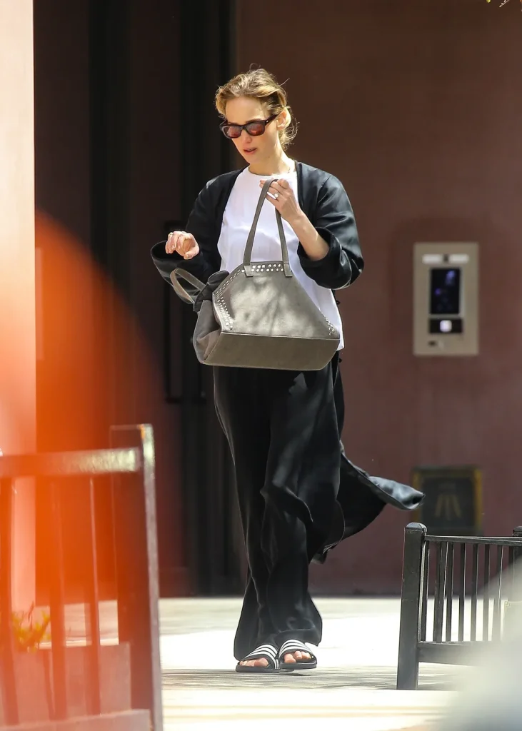 Image may contain Clothing Dress Black Hair Hair Person Formal Wear Head Adult Face Evening Dress and Photography